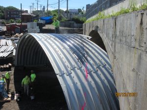 rehabilitation of an existing concrete arch custom buried bridge