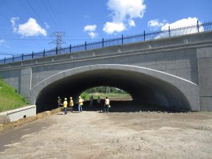 rehabilitation of an existing concrete arch custom buried bridge