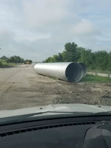 Corrugated metal pipe staged for installation as part of the Lincoln South Beltway project.