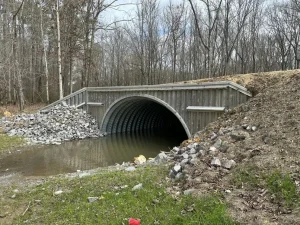 IMG_2765_resized Natural stream channel flowing through a newly installed corrugated steel culvert after habitat restoration.